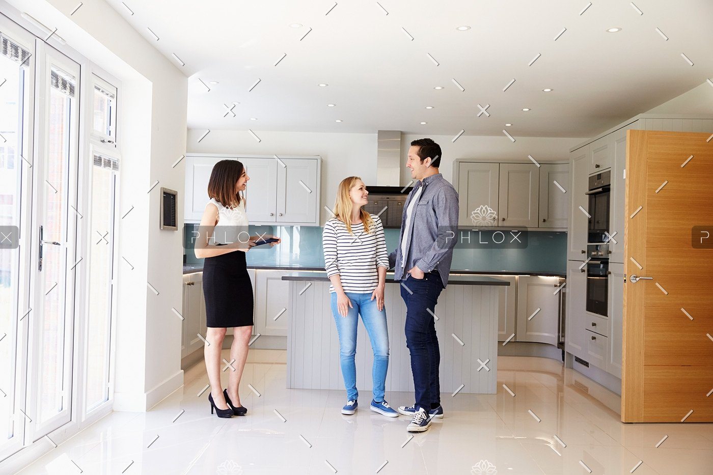 demo-attachment-103-realtor-showing-young-couple-around-property-for-PDHK2DX